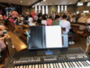 family mass at Chris the King with close up of music keyboard