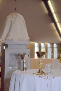 Holy sacrament - goblets and eucharist in background